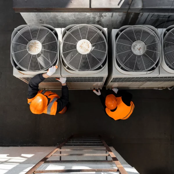 Técnicos trabajando en el mantenimiento de un refrigerador industrial